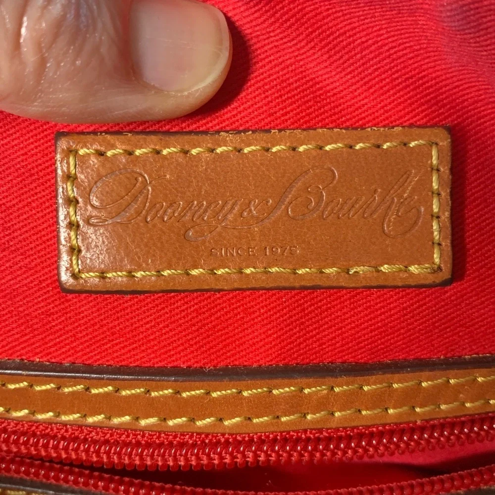 Dooney & Bourke black nylon crossbody bag with brown leather strap and accents